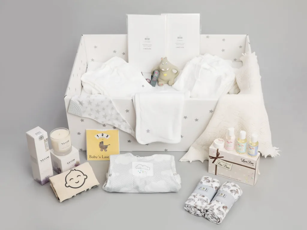 a baby's gift hamper with its contents laid out